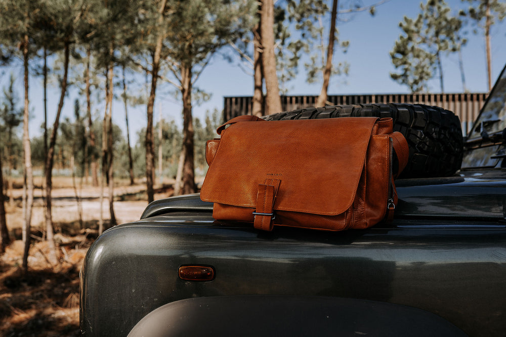 leather messenger bag on a Land Rover discovery